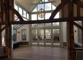 An image showing a large room with newly fitted decorative hanging ceiling lights