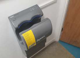 An image showing a newly fitted hand dryer in a commercial bathroom